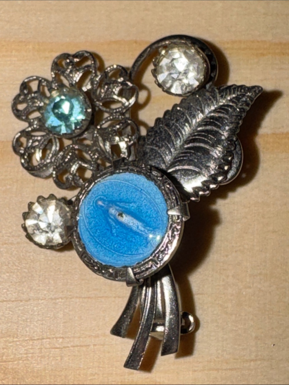 Mid-century silver-tone rhinestone and enamel Virgin Mary devotional brooch.
